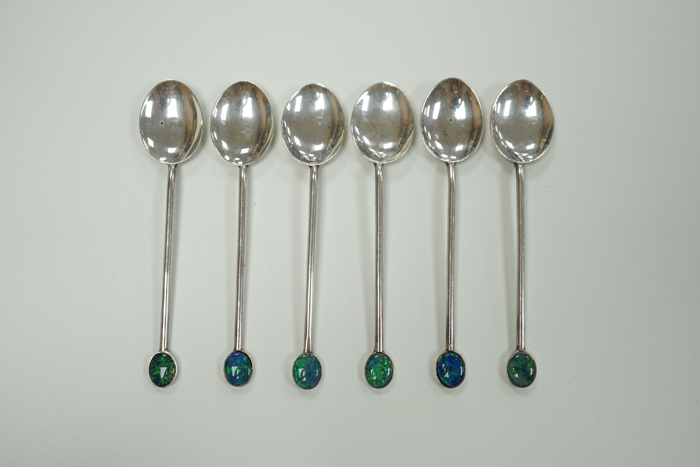 A set of six Australian sterling coffee spoons, with oval black opal doublet set terminals, 92mm.